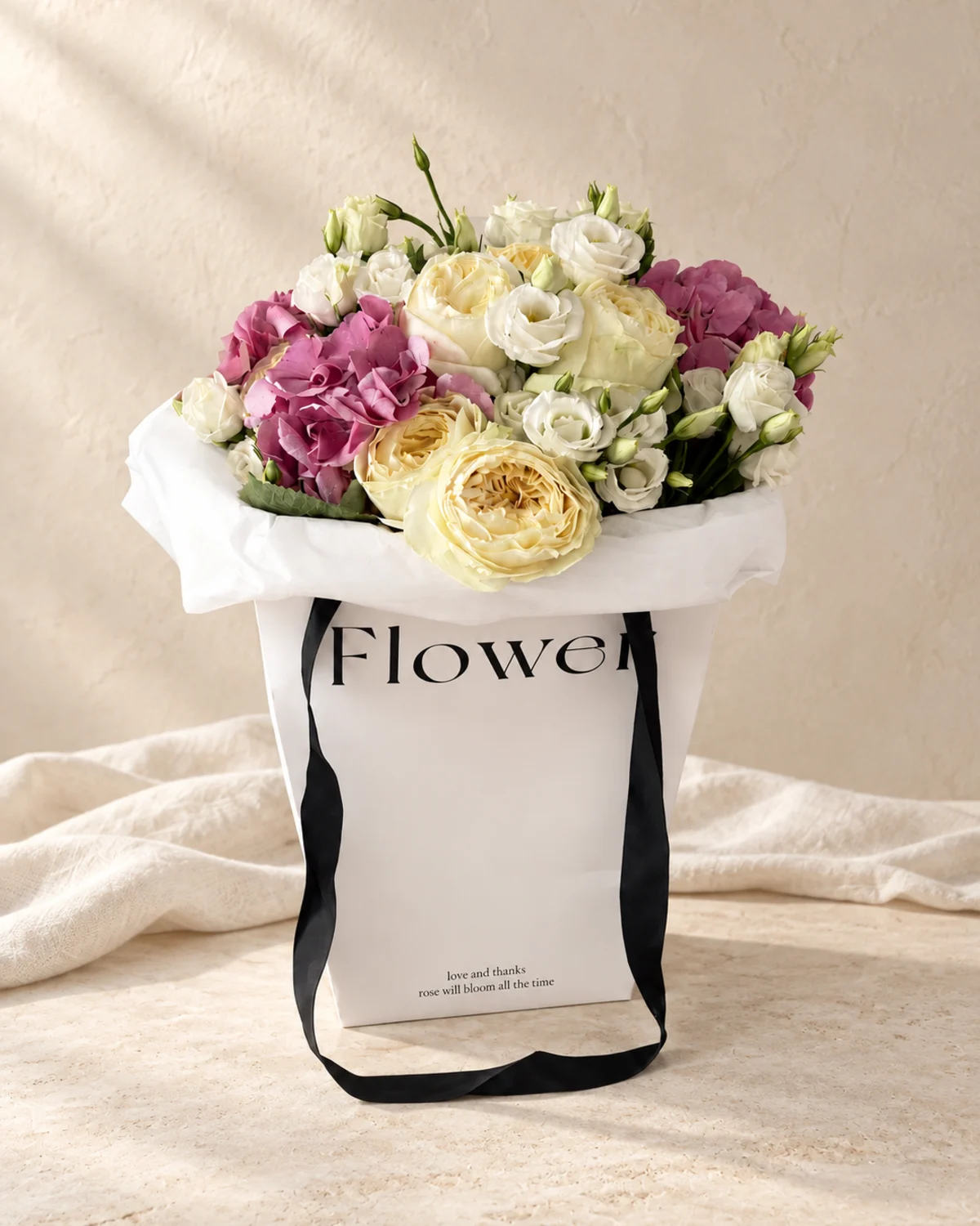 Pink hydrangea, cream garden roses and lisianthus in a luxury flower bag - flower delivery in Prilep